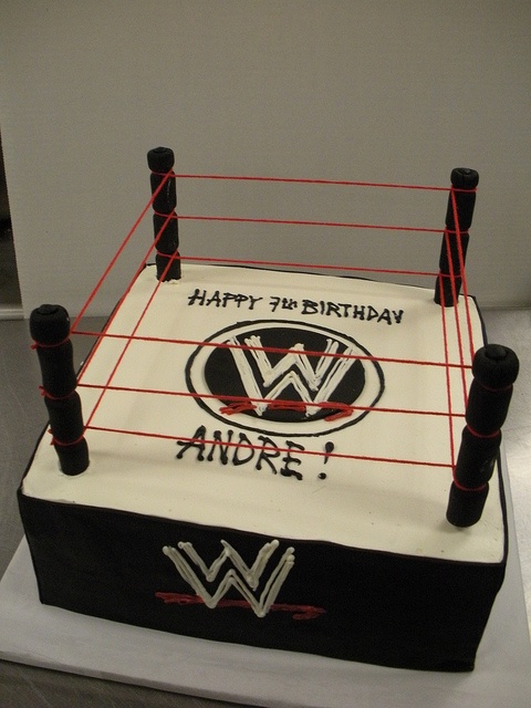 a birthday cake that is shaped like a wrestling ring