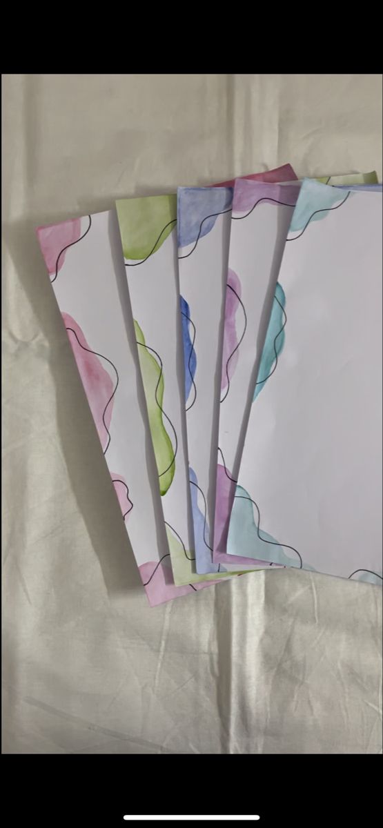 four pieces of paper with different designs on them