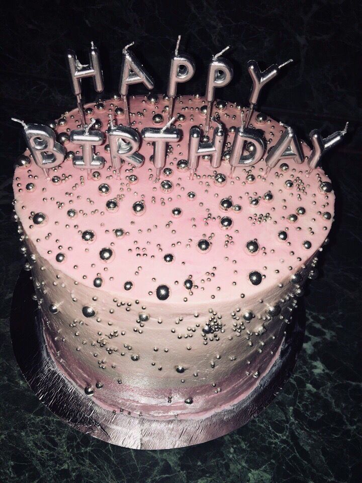 a birthday cake with pink frosting and sparkles