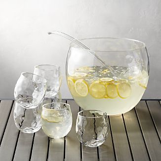 a pitcher and glasses filled with lemonade on a table