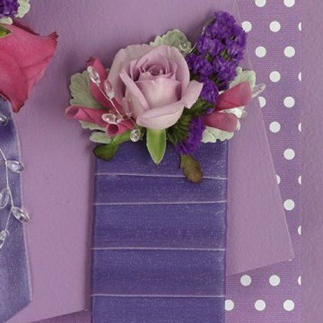 two purple vases filled with flowers on top of a table