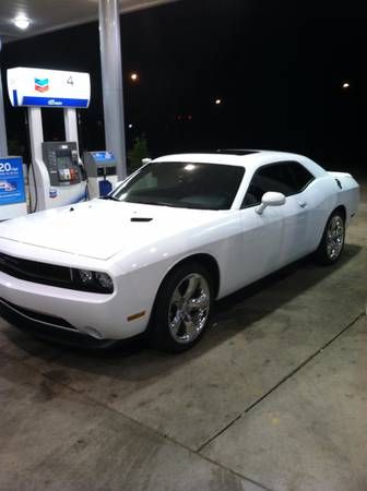 a white car is parked at a gas station