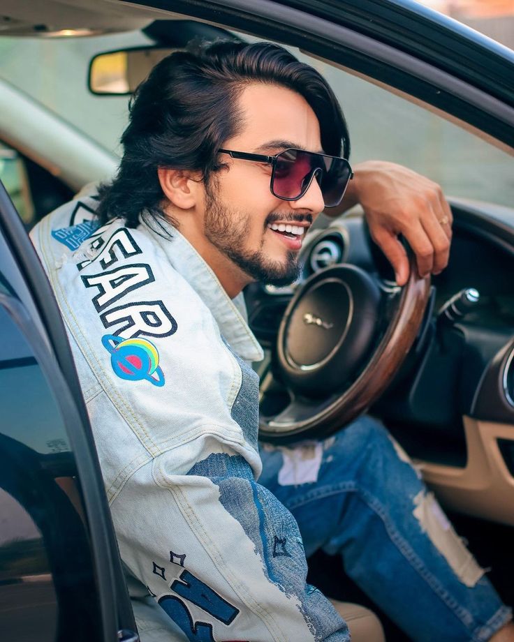 a man sitting in the driver's seat of a car