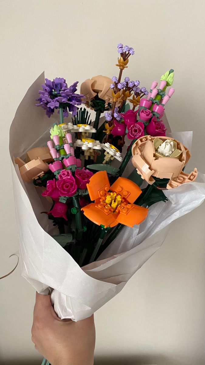 a person holding a bouquet of flowers in their hand