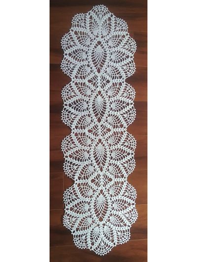 white crocheted doily on wooden floor