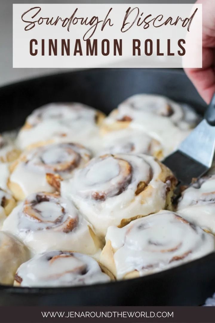 a pan filled with cinnamon rolls covered in icing