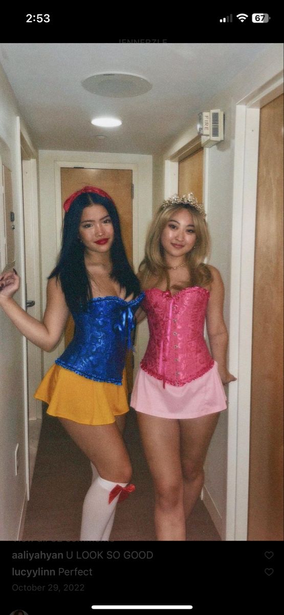 two women dressed in costumes standing next to each other