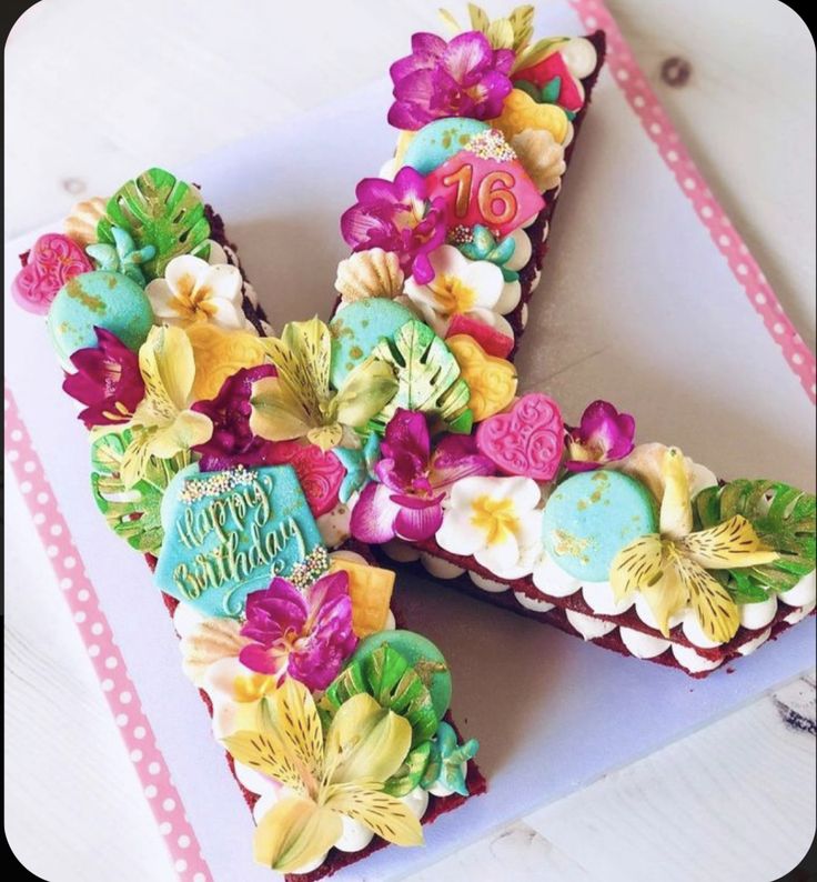 the letter k is decorated with flowers and icing