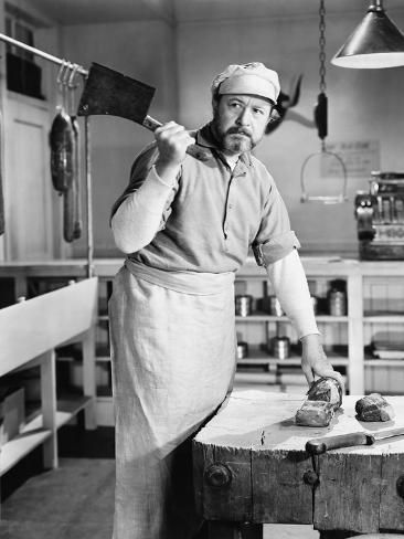 an old black and white photo of a man working in a shoe factory with his hammer