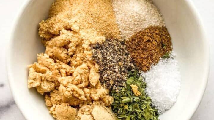 an assortment of spices in a white bowl