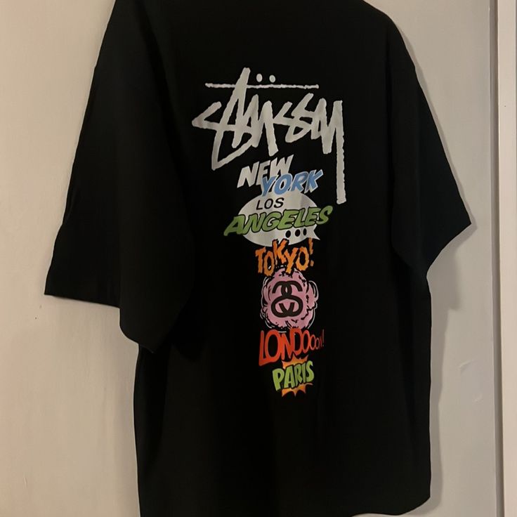 Questions? Leave A Comment Below! Stussy New York London Paris Tokyo Los Angeles T-Shirt 2xl White Black And Multicolor Brand New No Tags 24” Armpit To Armpit 29” Length Stussy Tee, Skate Boy, Tshirt Oversized, Nyc Subway, York London, Black Tshirt, White Color, Black Blue, Air Jordan