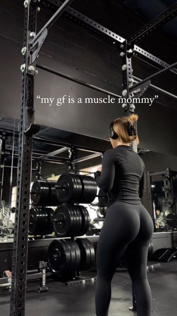 a woman standing in front of a gym machine with the caption, my girl is muscle mommy