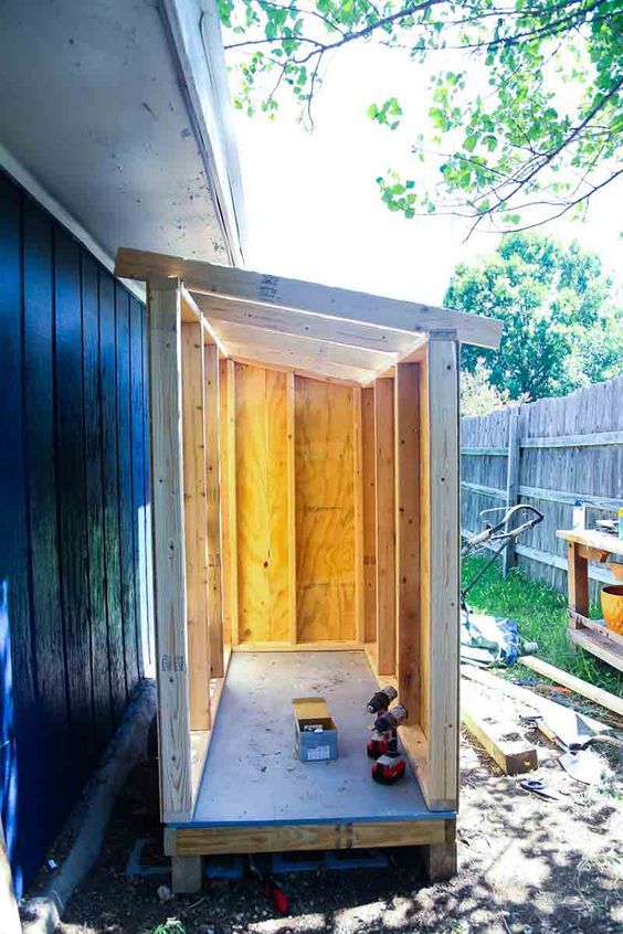 the back side of a shed with some tools in it