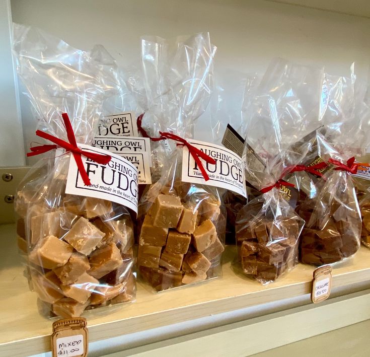 several bags of fudge sitting on top of a shelf