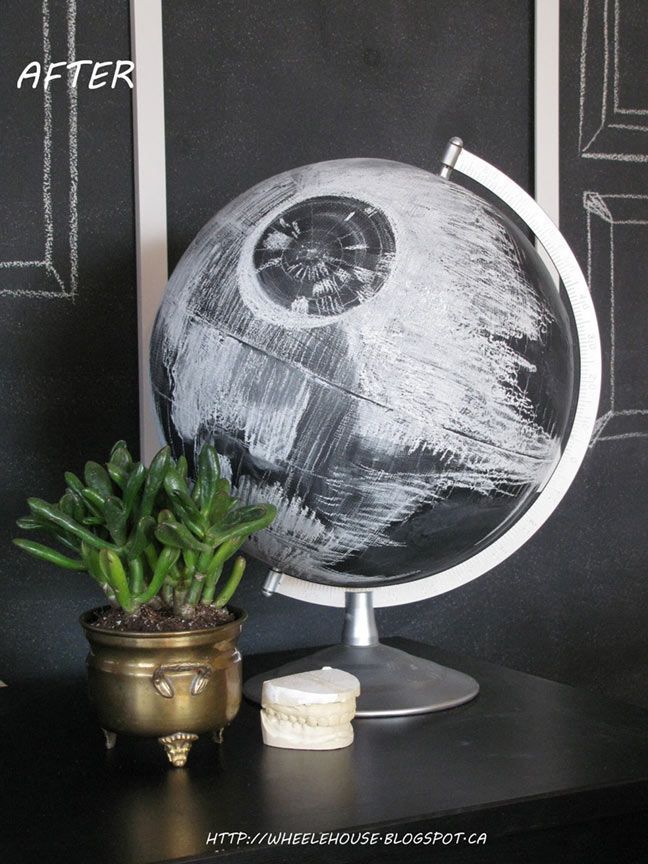 a potted plant sitting on top of a table next to a black and white globe