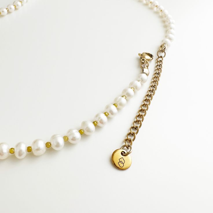 Elevate your style with our Danielle Pearl Necklace, featuring hand-picked freshwater potato pearls and small gold beads. The delicate design showcases the natural beauty of the pearls while adding a touch of sophistication with the gold accents. A must-have accessory for any occasion, this necklace is both cute and elegant. Handmade in San Francisco. Material: 0.2"/5mm freshwater pearls, gold-plated beads Length: 14"/355mm with 2"/50mm chain extender, total 16"/400mm Minimalist Pearl White Beaded Necklaces With Pearl Charm, Minimalist Pearl White Beaded Necklace With Pearl Charm, Minimalist Pearl Necklace With Tiny Beads, Delicate Everyday Beaded Necklace With Pearl Chain, Yellow Gold Pearl Necklace With Gold Beads As Gift, Dainty Everyday Beaded Necklaces With Pearl Charm, Yellow Gold Pearl Necklace With Gold Beads, Dainty Everyday Beaded Pearl Necklace, Gold Baroque Pearl Beaded Necklaces With Round Beads