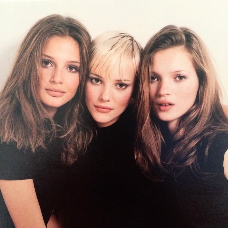 three women are posing for the camera together