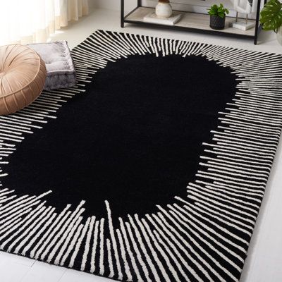 a black and white area rug on the floor