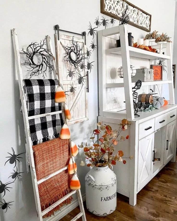 an old ladder is used as a shelf for halloween decorations