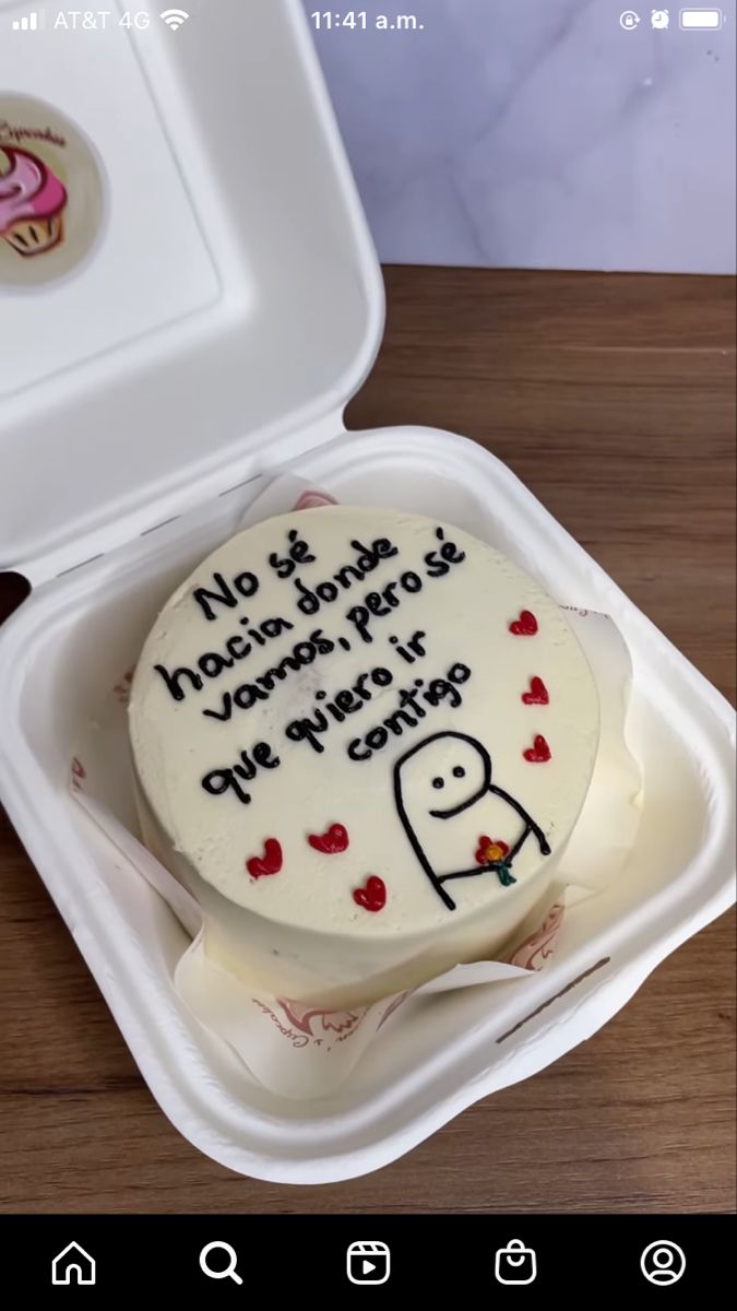 a white cake in a plastic container with writing on it