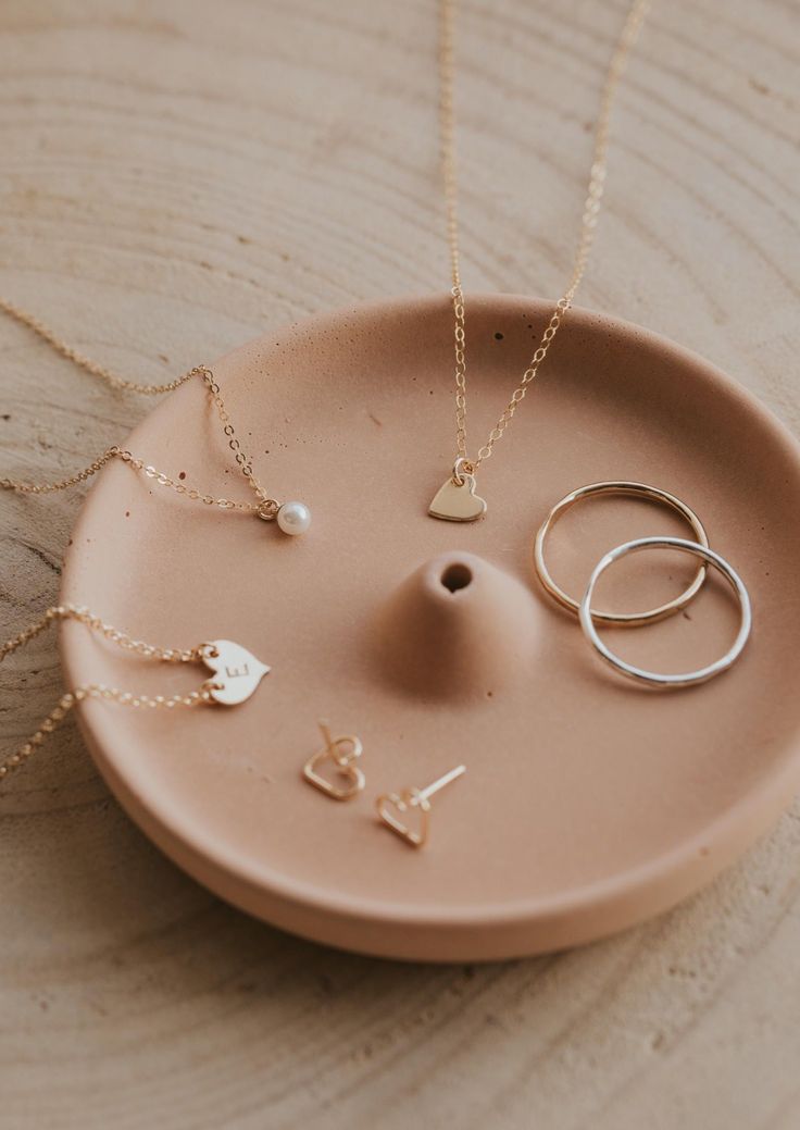 Take dainty and adorable to the next level with our Tiny Heart necklace. Made with our delicate cable chain, this subtle heart charm necklace is a sweet salute to love. 15" of our delicate chain + 1" of extender chain. Available in 14kt Gold Fill + Sterling Silver. KJ pairs it with our Confetti Choker. Olivia stacks it with our Dylan Chain and Blake Initial Necklace. Shown on Abbie layered with our Maeve Chain. Handmade in Eau Claire, WI. Our jewelry is handmade so each piece will be unique and Tiny Heart Necklace, Copper Uses, Everyday Wear Jewelry, Heart Charm Necklace, Love Pendant, Delicate Chain, Tiny Heart, Jewelry Cleaner, 14kt Gold