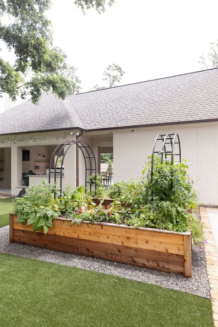 an outdoor garden is shown in front of a house