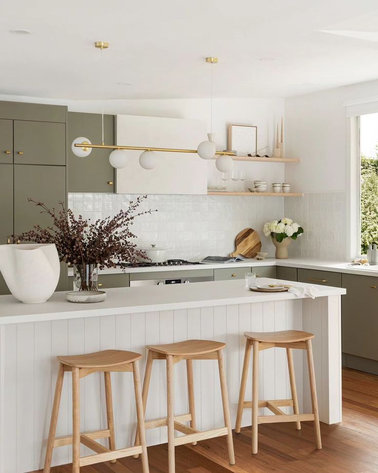 two stools sit on the counter in this modern kitchen