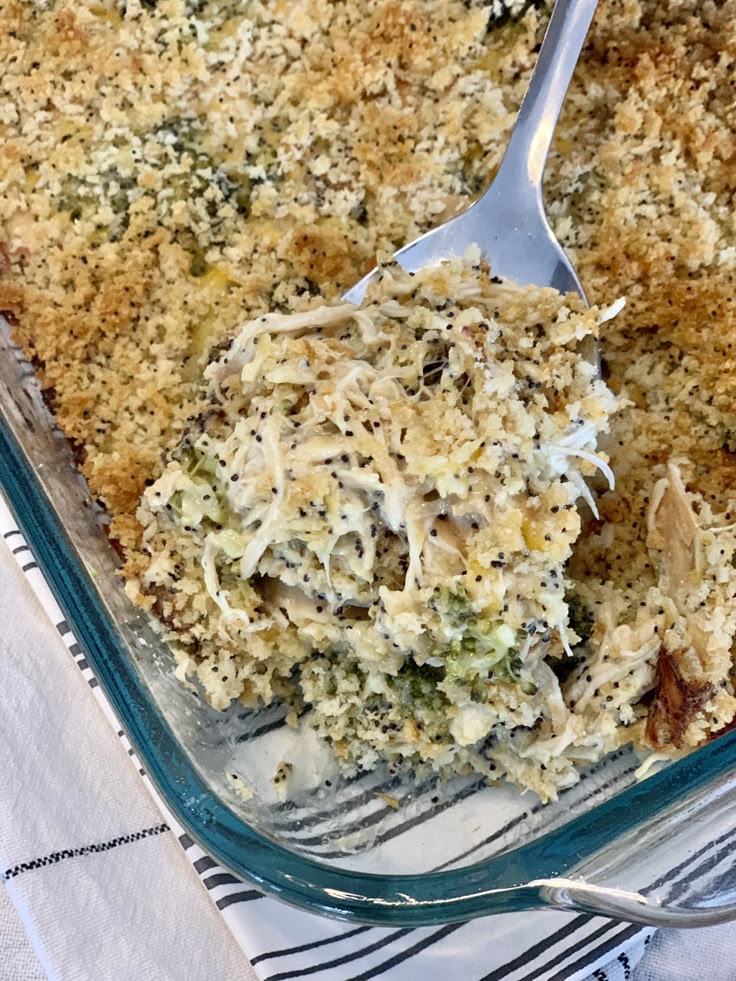 a casserole dish with broccoli and cheese on top, ready to be eaten