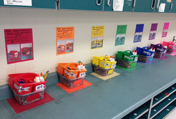 several bins are lined up on the wall in front of each other with different colors