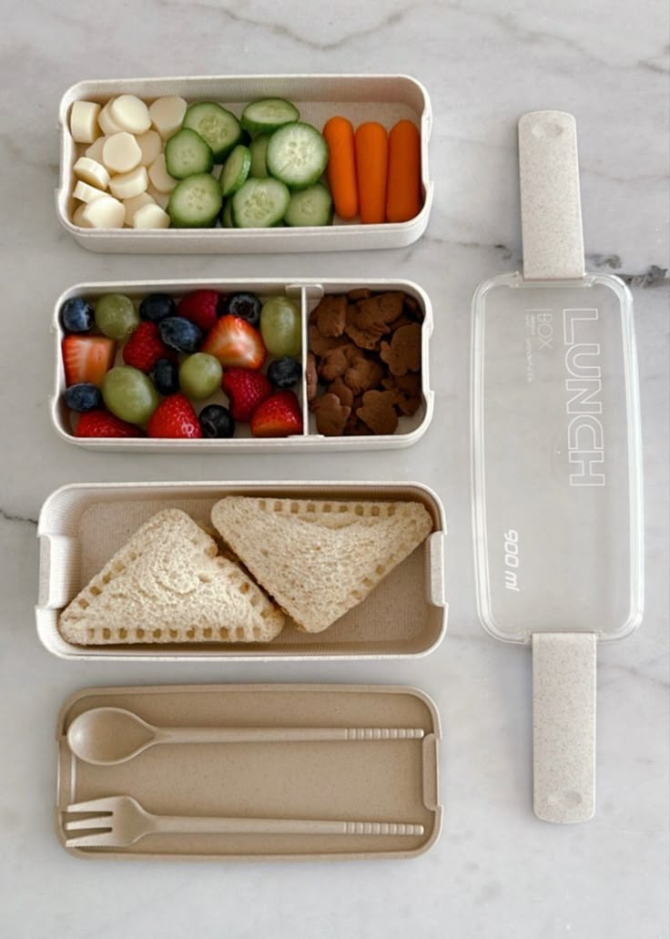 three plastic containers filled with food on top of a marble countertop next to utensils