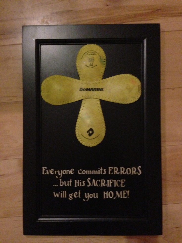 a black frame with yellow paper cut out of a man's face and words on it