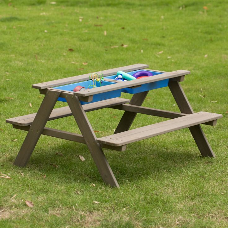 a picnic table with two benches on the grass