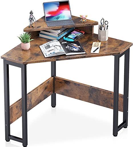 a laptop computer sitting on top of a wooden desk next to a potted plant