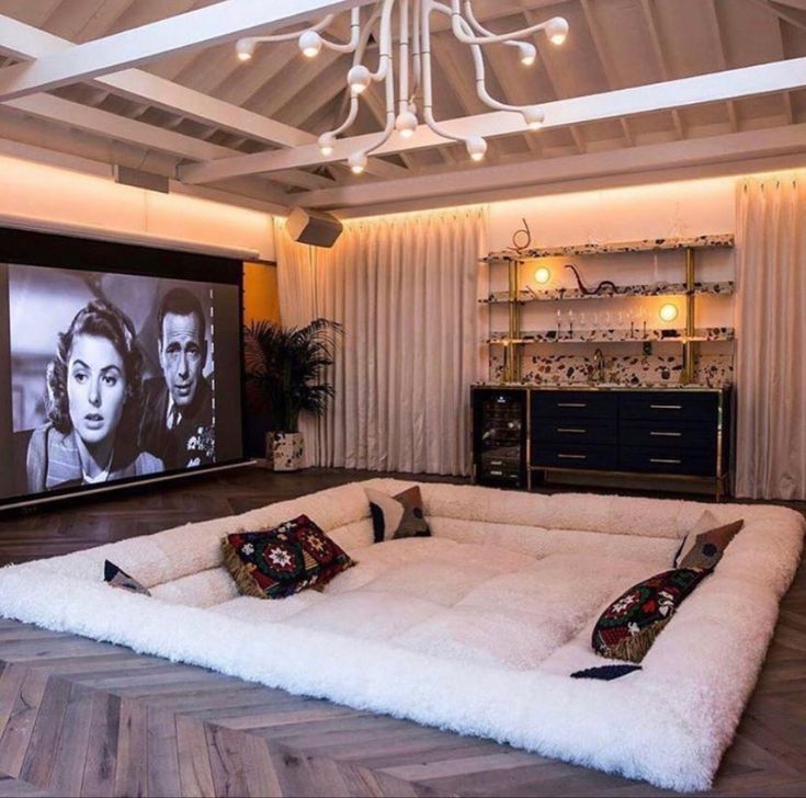 a living room filled with furniture and a flat screen tv mounted to the wall above it