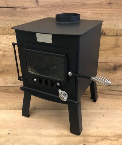 a black stove sitting on top of a wooden floor