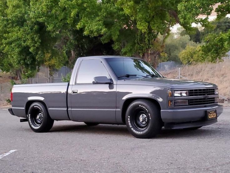 a silver truck parked in a parking lot