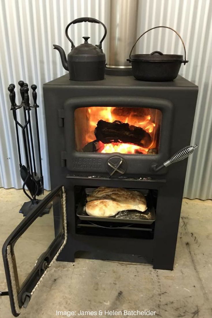 an oven with some food in it and two tea kettles on the stove top