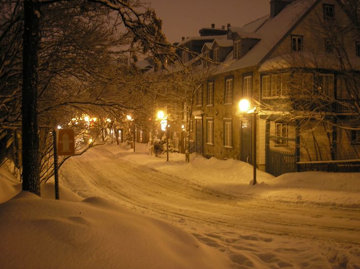 a street is covered in snow at night