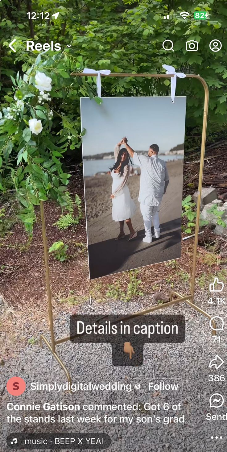 a couple is walking down the street with their wedding pictures hanging from clothes pins on them