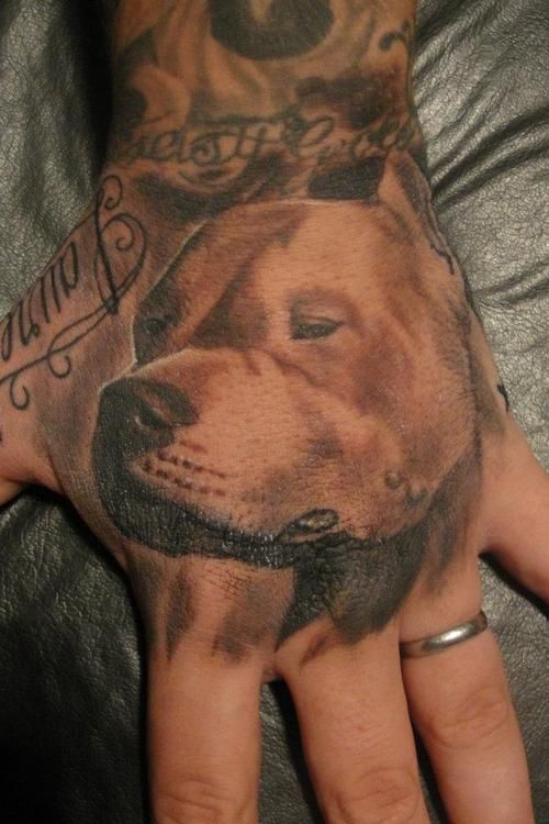 a hand with a dog's face on it and some writing on the palm