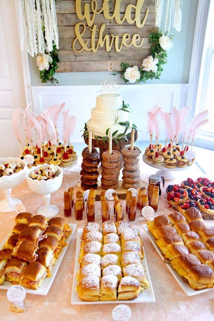 a table topped with lots of pastries and desserts