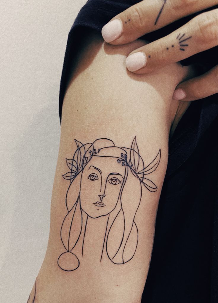 a woman's arm with a tattoo on it