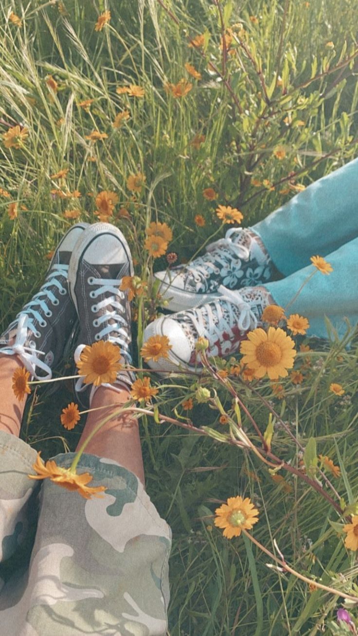 someone's feet in the grass with yellow flowers