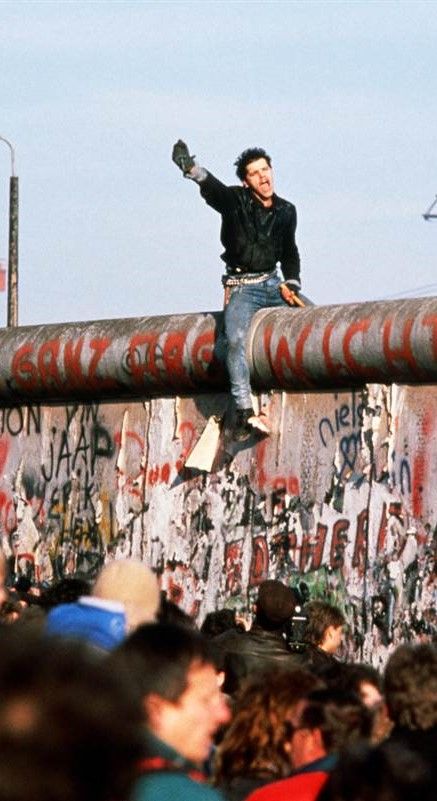 a person sitting on top of a metal pipe with graffiti all over it and the words who are you?