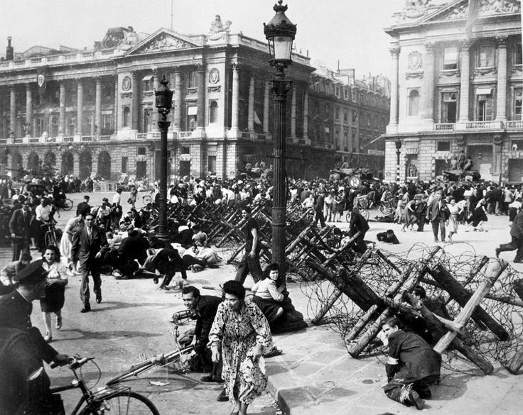 an old black and white photo of people in front of a building with lots of debris