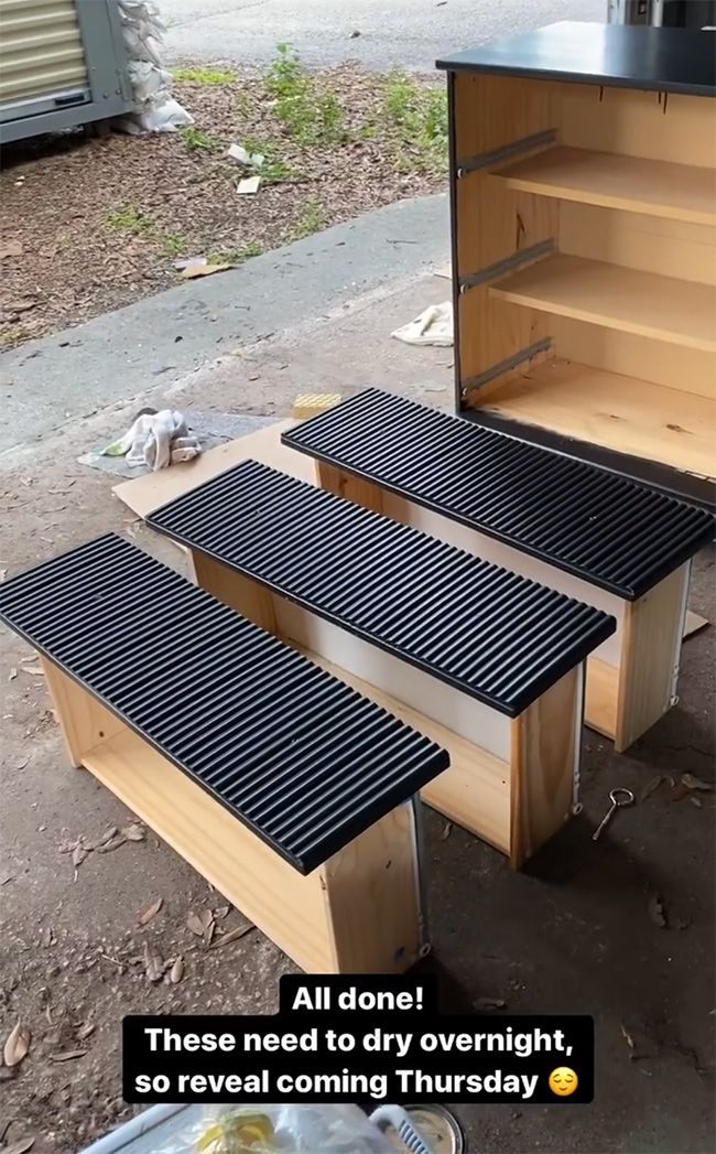 two bbq grills sitting next to each other on the side of a road