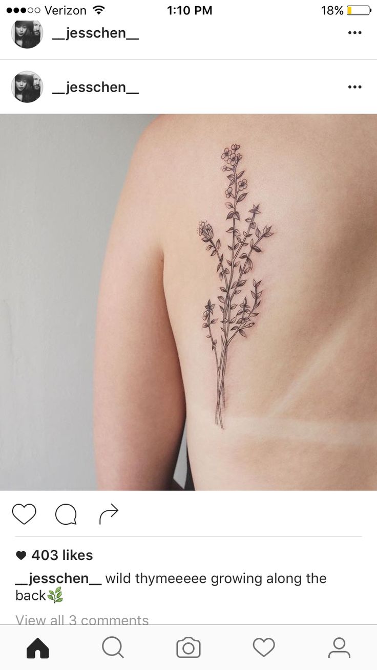 the back of a woman's shoulder with flowers tattooed on her left arm and chest