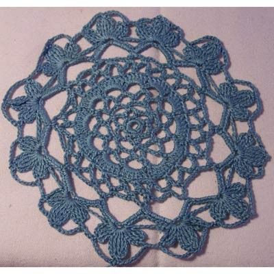 a blue crocheted doily on a white background