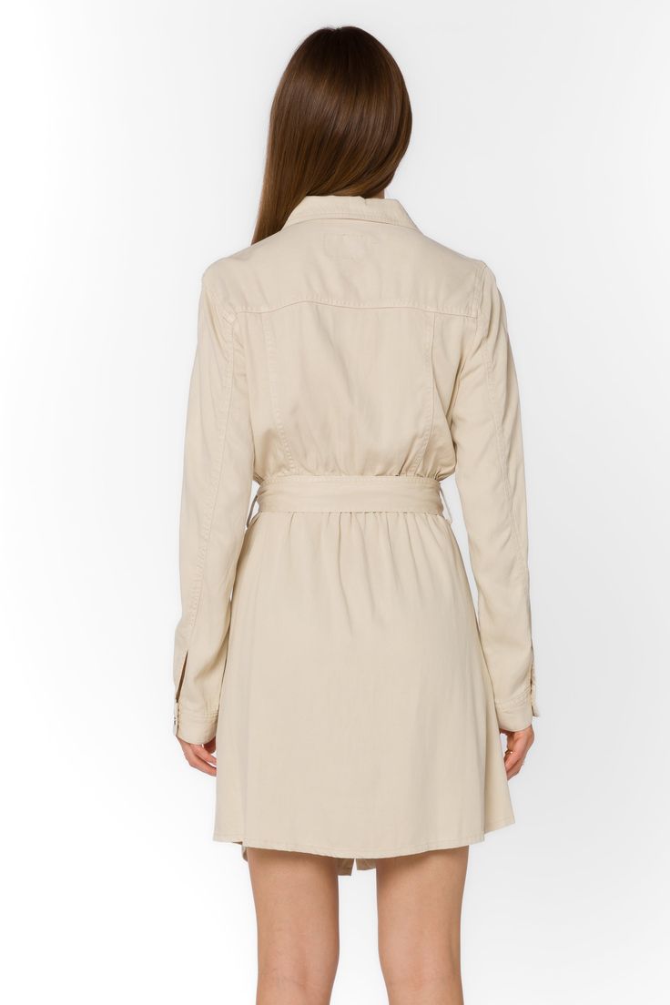 Add some sophistication to your wardrobe with the Deena Dress. This soft mini shirtdress features a stylish collar and snap button closure. With long sleeves and functional pockets, it's both practical and trendy. Complete the look with the self-belt for a flattering fit. Material: 60% Tencel™ and 40% Linen Machine wash cold or dry clean Color: Wheat Model is 5'9" and wearing a size S Imported Fall Collared Belted Dress With Belted Cuffs, Collared Belted Dress For Work In Fall, Fall Collared Belted Dress For Work, Chic Button-up Belted Dress For Fall, Chic Fall Belted Button-up Dress, Chic Collared Mini Dress For Work, Fall Office Shirt Dress With Belted Cuffs, Elegant Mini Shirt Dress With Pockets, Belted Fitted Shirt Dress For Fall