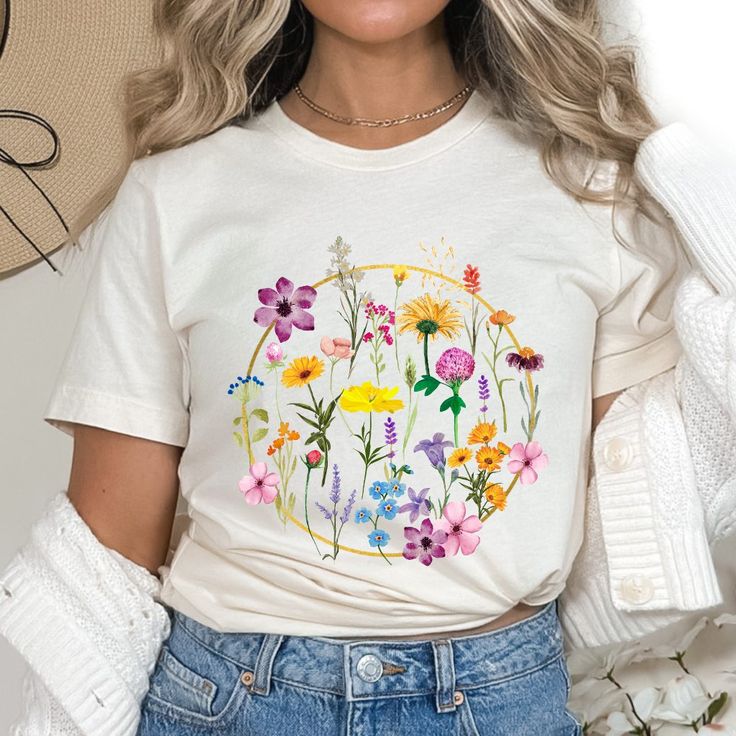 Brighten up your day! The colorful design of this wild flowers graphic t-shirt can bring a pop of color and joy to your outfit. This trendy wildflowers shirt is perfect for spring and summer and would make a great gift for birthdays or mother's day!
Connect with nature! Wearing this floral graphic t-shirt can help you feel more connected to nature, even if you are not able to spend time outdoors. Flower Shirt Aesthetic, Floral Minimalist, Flowers Graphic, Minimalist Shirts, Botanical Shirt, Shirt Aesthetic, Ladies Shirt, Floral Graphic, Aesthetic T Shirts